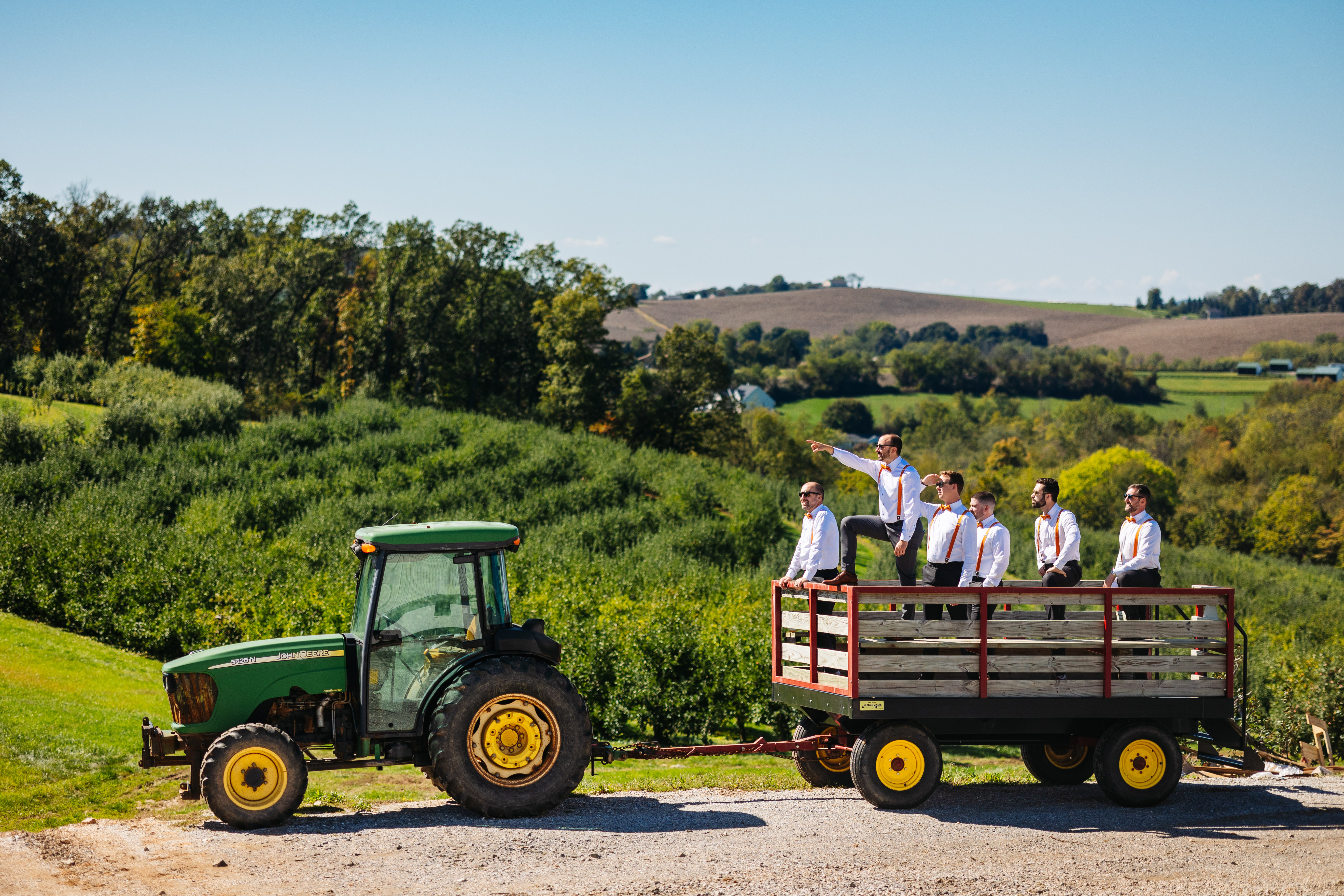 A photo of the groom and groomsmen standing in the back of a trailer